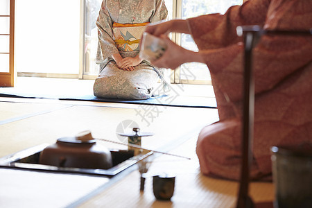 在茶室用器具享受茶道的妇女图片