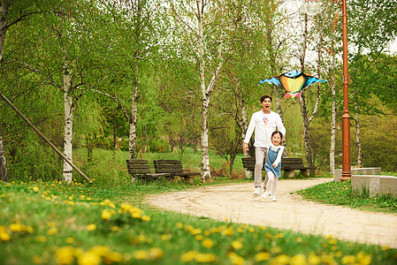 爸爸和女儿在公园里放风筝图片
