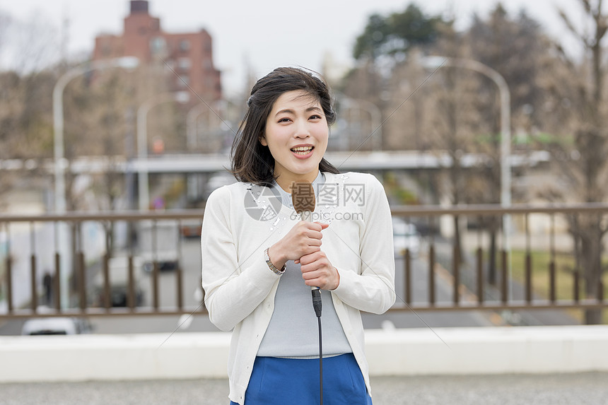 寒冷天气播报新闻的女青年图片