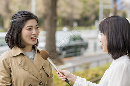 拿着话筒街头采访的女播音员图片