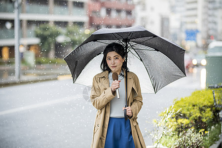 下雨天街头播报新闻的女记者图片