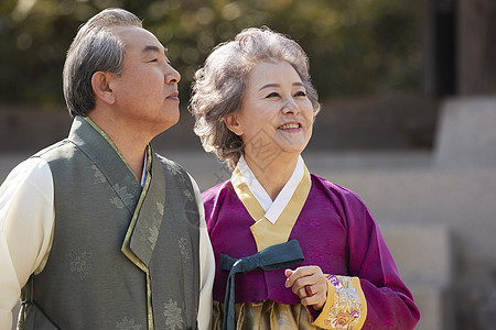 穿着传统服装看风景的老年夫妇图片