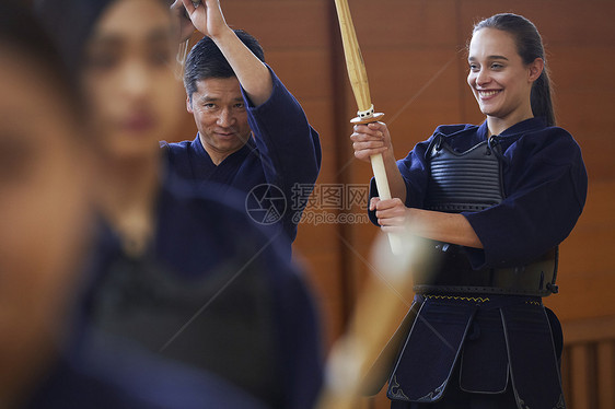 拿着木剑跟着教练学习的女孩图片