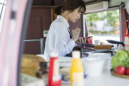 餐车里制作食物的年轻女性图片