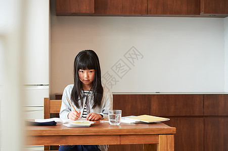 家族年轻的女孩集中精力家庭学习女孩在餐厅学习图片