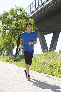 公园里慢跑锻炼的男青年图片