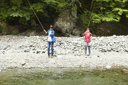 年轻女性享受户外钓鱼乐趣图片