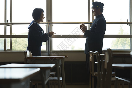 一对情侣在教室里聊天背景图片