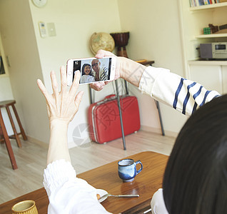 女人敲击短发高级夫妇咖啡时间智能手机摄影图片