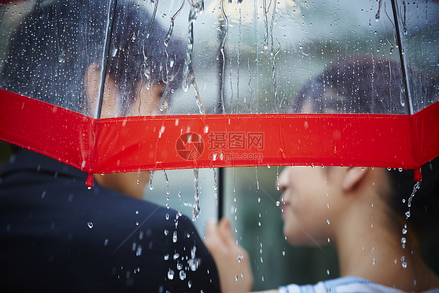 亚洲人有趣笑脸走在雨中的夫妇图片