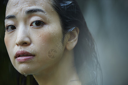 户外淋雨的年轻女人背景图片