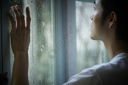 雨天看着窗外的成年男性图片