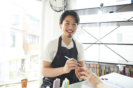 男店员在给客户修美甲图片