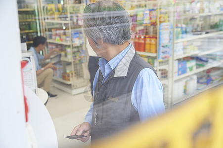 使用便利店atm的老年男人图片