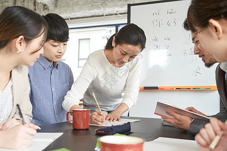 学校讲师辅导学习语言的学生图片