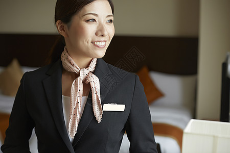 谦恭的美丽亚洲人在酒店工作的女图片