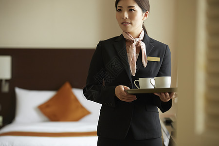 日本酒店服务员雇员好客明亮在酒店工作的女背景