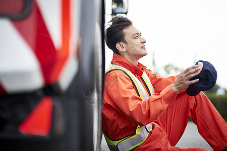 靠着车辆休息的道路救援服务人员图片