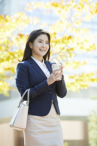 拿着咖啡微笑的女青年图片