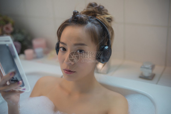 居家美女浴缸泡澡玩手机图片