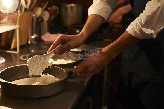 在咖啡店厨房认真工作的年轻男女图片