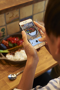 香料餐厅咖喱男子用智能手机拍摄食物图片