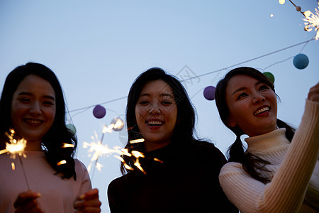 年轻女子在户外聚会放烟火图片