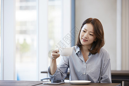 咖啡馆休息喝咖啡的青年女子图片