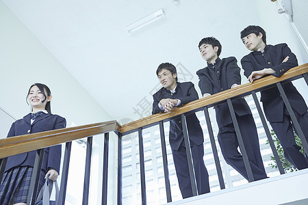 日式制服的学生靠在楼梯扶手上聊天图片
