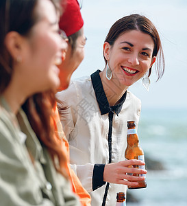 海岸边聚会派对的青年男女喝酒图片