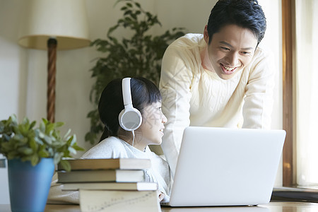 戴着耳机线上学习的小女孩图片