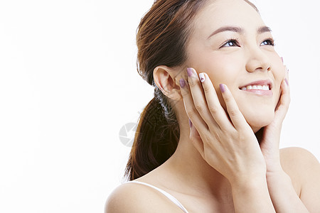 双手捧脸微笑的甜美少女图片素材