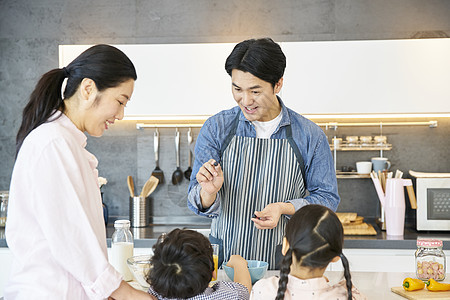 在家庭厨房里做饭的一家人图片