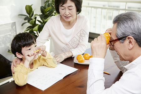 爷爷看着小男孩写字图片