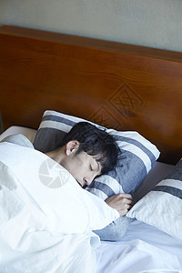 床上熟睡的青年男子图片