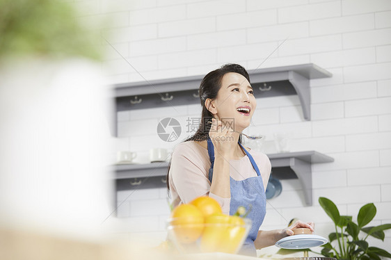 拿着勺子试吃开心的年轻女子图片