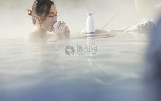 女人露天泡温泉喝清酒图片