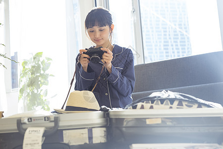 居家拿着相机的女青年图片