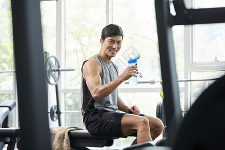 健身馆的男子喝水休息图片