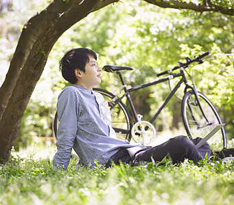坐在草坪上放松休息的男子图片