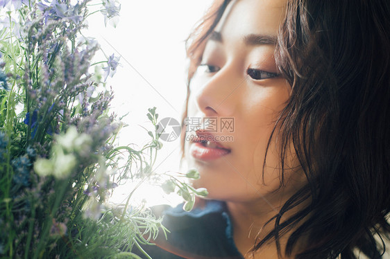 年轻美女捧着鲜花图片