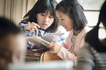 小学生在老师的指导下学习平板电脑使用知识图片