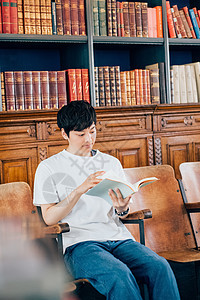 图书馆里阅读书籍的青年男子图片