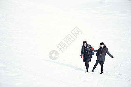 雪地上散步聊天的高中生图片