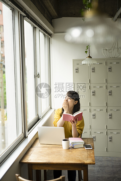 坐在咖啡馆学习的女性图片