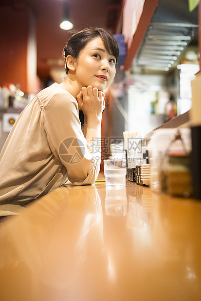 夜晚餐厅晚餐一个独自享受拉面的女人图片