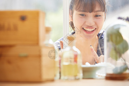 年轻女子看着橱窗里的商品微笑图片