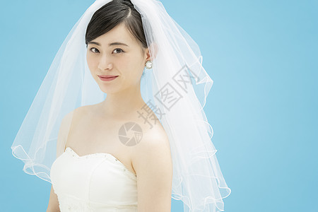 穿着婚纱佩戴头纱微笑的新娘图片