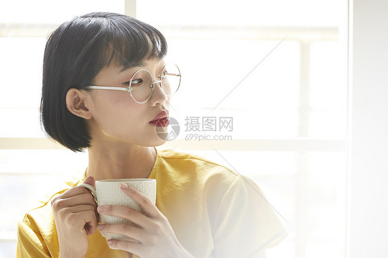 手拿水杯的女性图片