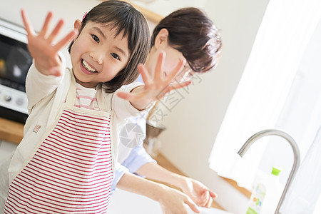 笑容菜品活力父母和孩子的生活在厨房洗手的母女图片